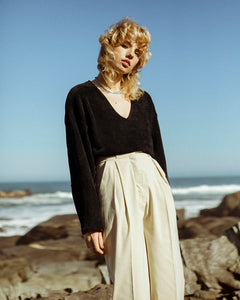 model wearing a black, velvet, v-neck crop jersey