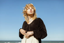 Load image into Gallery viewer, blonde fashion model wearing a black, velvet, meg taljaard, crop jersey 