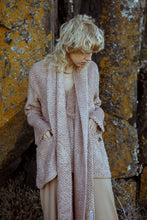 Load image into Gallery viewer, Blonde model standing in front of rocks, wearing a pink, textured fashion outfit 