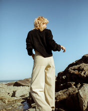 Load image into Gallery viewer, back view of a model wearing beige, high waisted trousers  